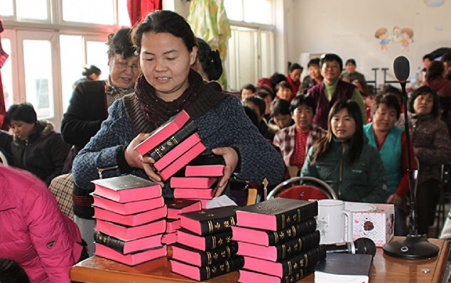 woman distributing bibles